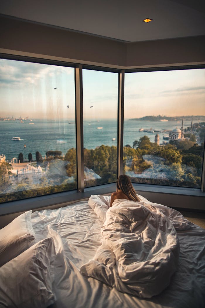 Relaxing in a cozy hotel room with stunning views of the Bosphorus at sunset in Istanbul, Turkey.