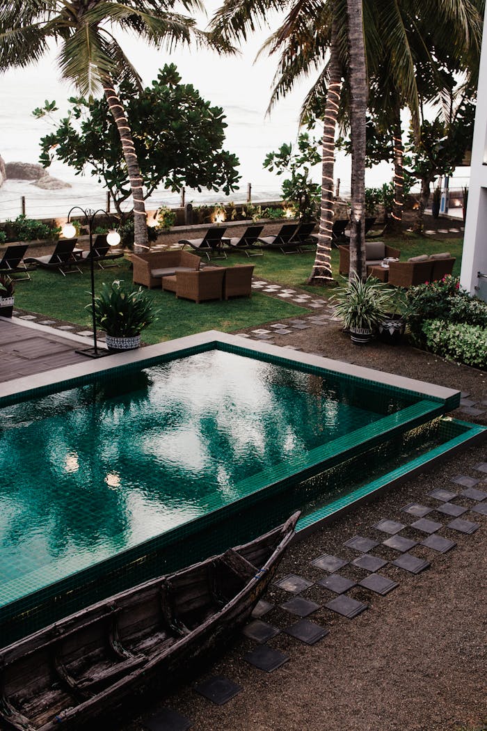 Offerings Inviting resort poolside area with palm trees, lounge chairs, and lush greenery at a tropical paradise.